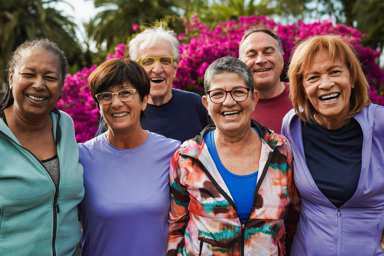 Group of senior friends smiling on camera after yoga lesson at city park Premier Senior Living in Lake County | AVIVA Merrillville